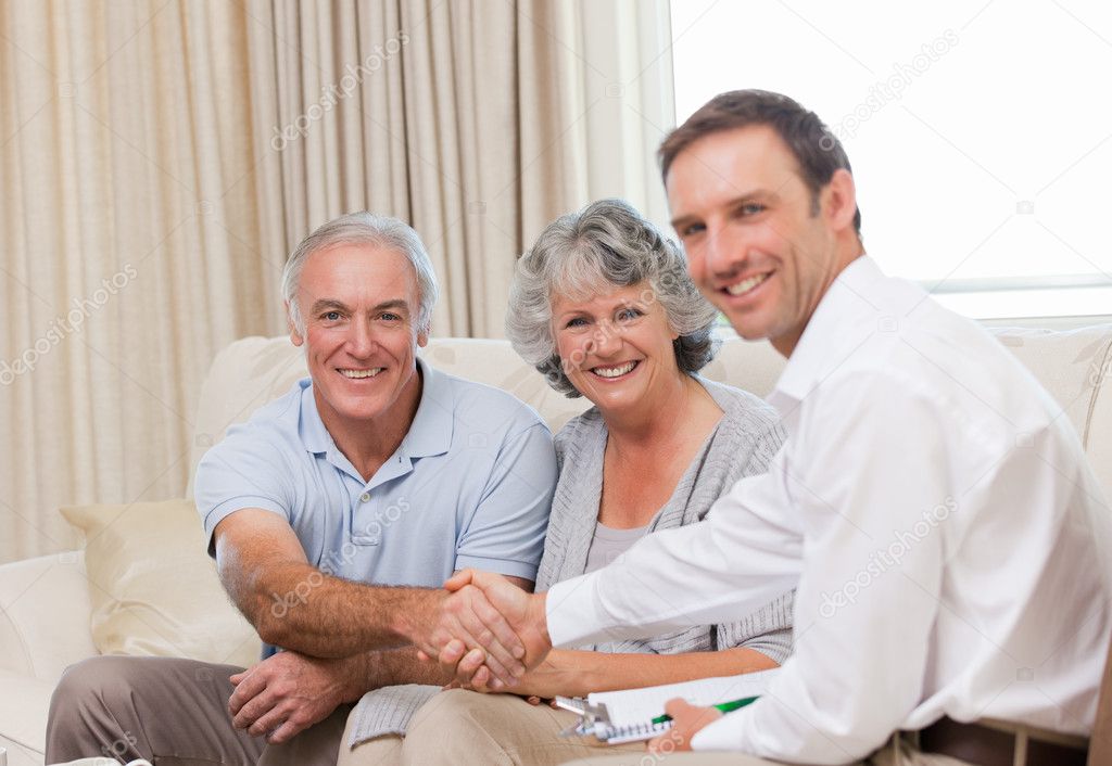 Senior holding a Medicare card while reviewing Medicare Advantage options.